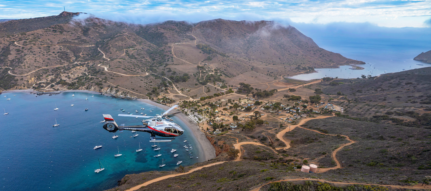 Maverick Helicopter flying over Two Harbors on Catalina Island, California