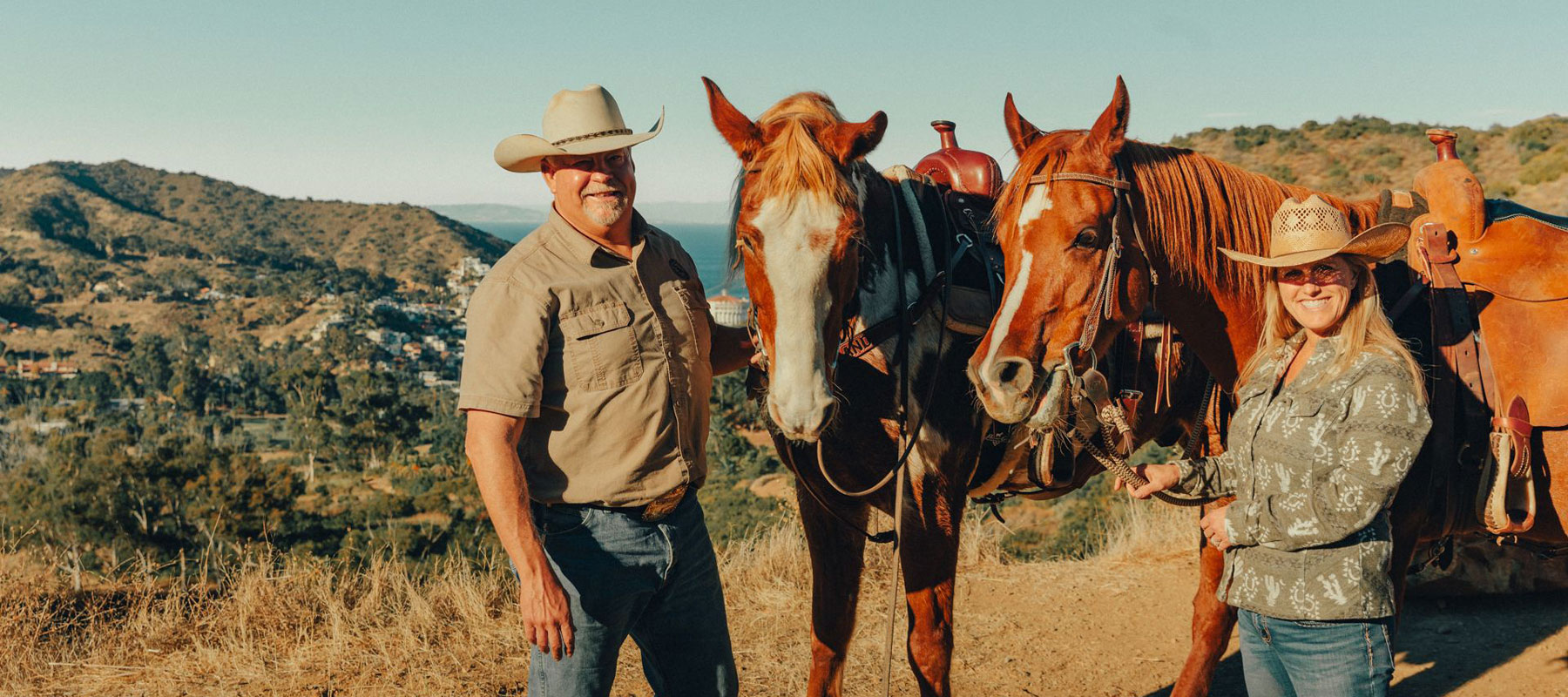 Ranch guides standing with their horses on Catalina Island
