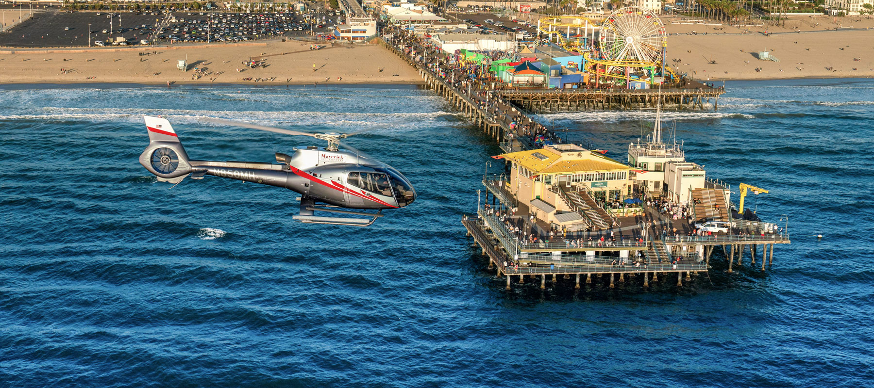 Maverick helicopter flying alongside Santa Monica Pier in California