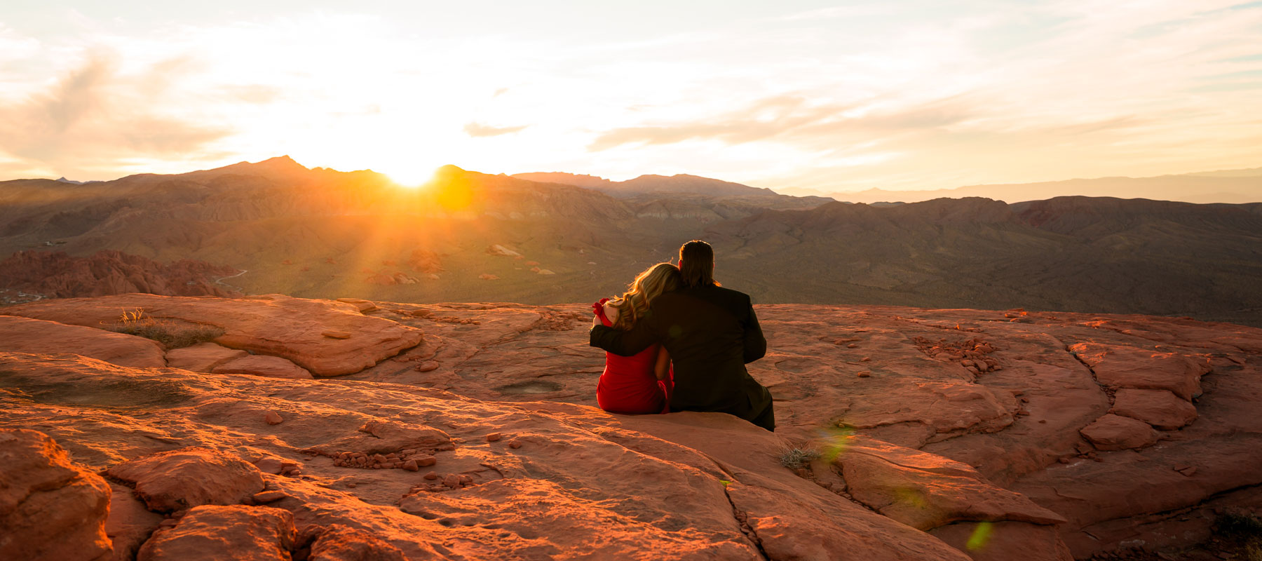 A couple sharing a sunset moment at Valley of Fire after a helicopter marriage proposal