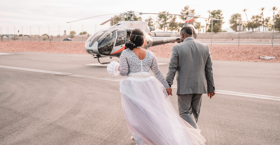 Bride and groom head to their helicopter for their night wedding cermony above the Vegas Strip